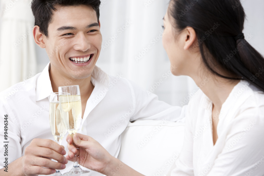 Happy young couple drinking champagne