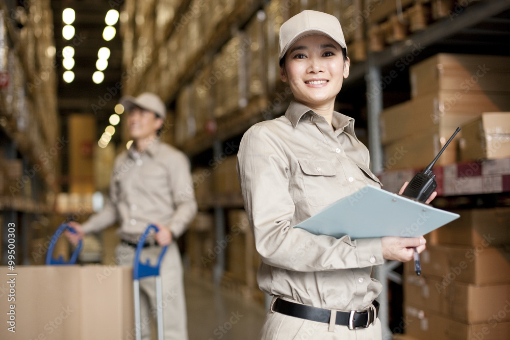 Male and female Chinese workers with walkie-talkie