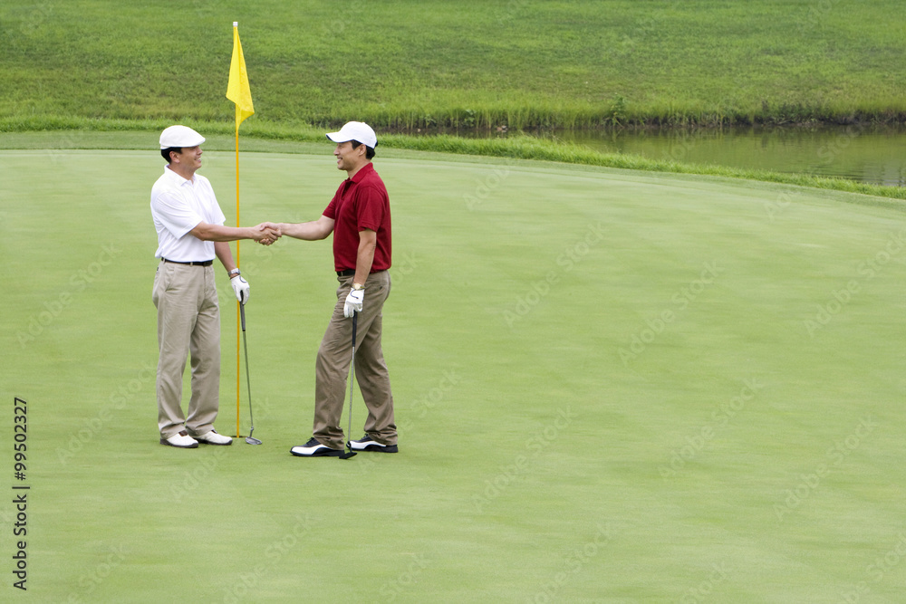 Two Golfers shaking hands on the Green