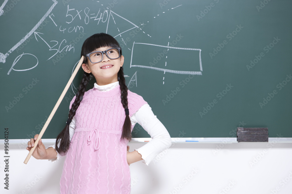 Humorous little girl playing teacher in classroom