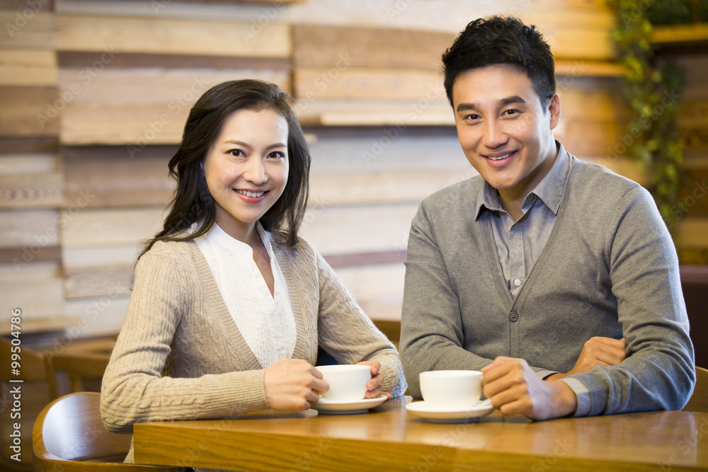 Young couple having coffee in cafe