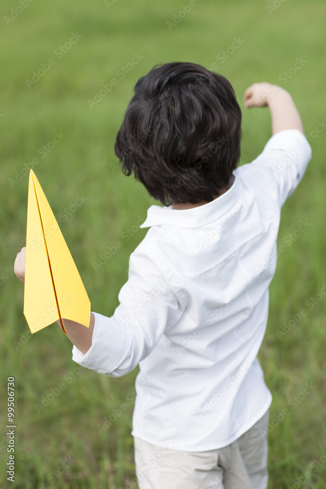 Little boy with paper airplane