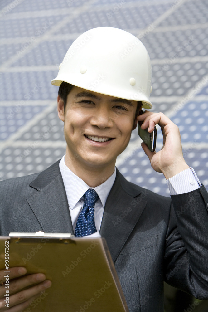 Portrait of an engineer in front of solar panels