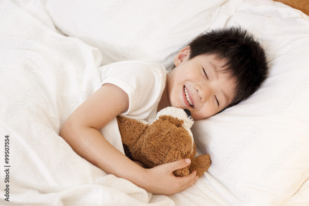 Little boy sleeping with teddy bear