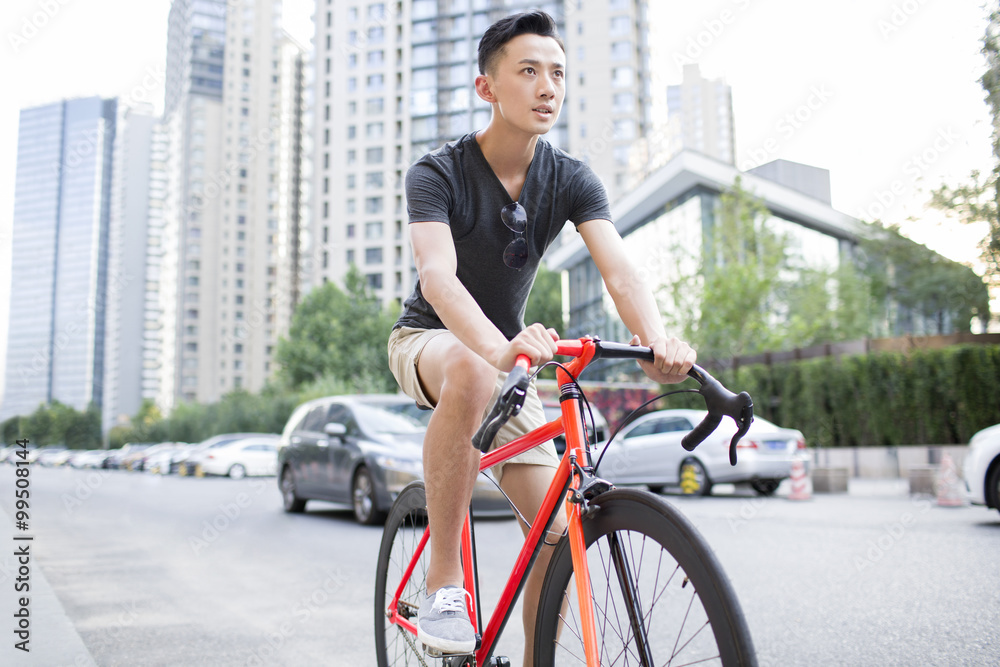 Young man riding bicycle