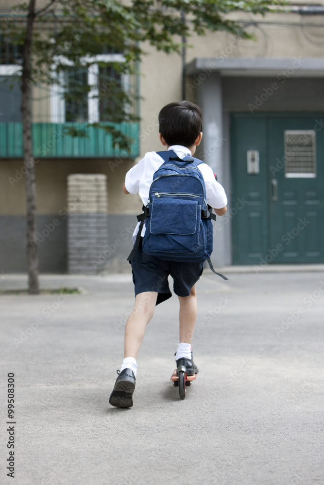 Boy on a push scooter