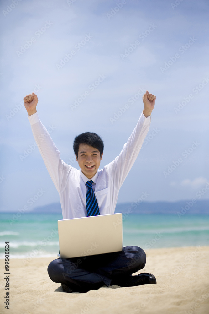 Businessman working at the beach