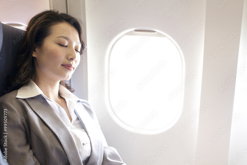 Businesswoman resting on the flight