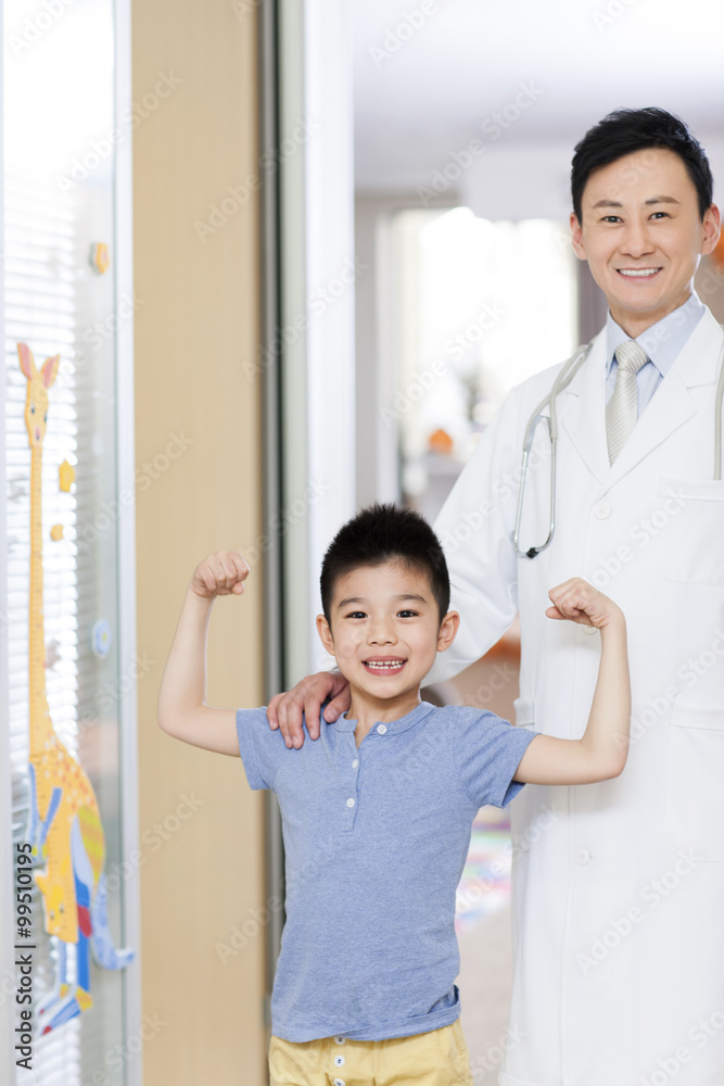 Happy doctor and boy in childrens hospital