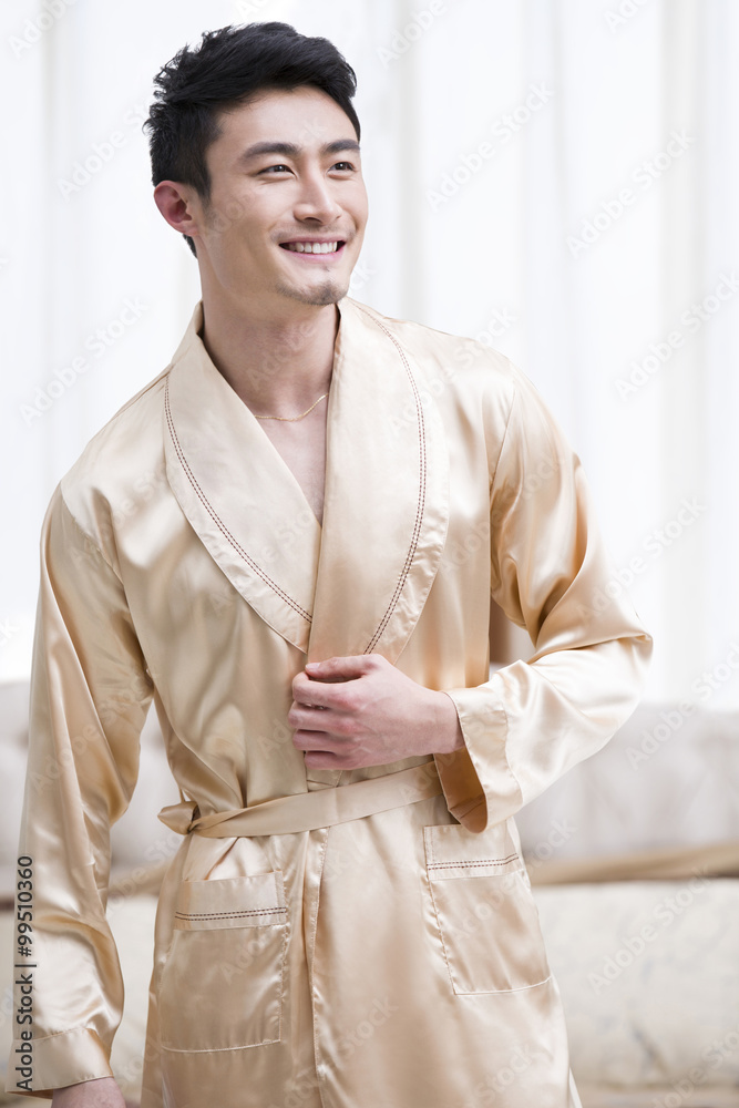 Cheerful young man in bedroom