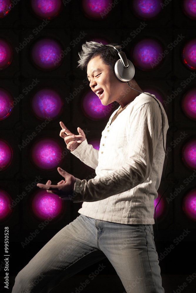 Young Man Performing On Illuminated Stage