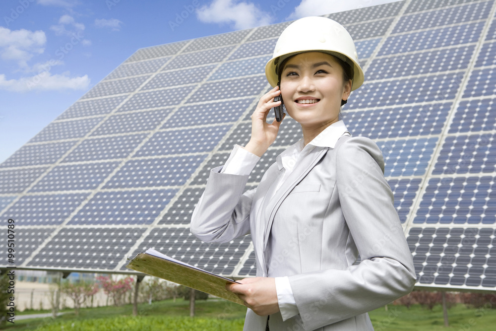 Portrait of an engineer in front of solar panels