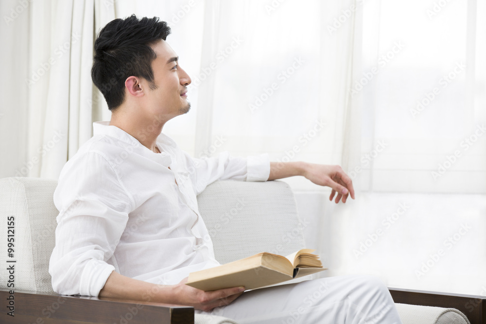 Happy young man with a book