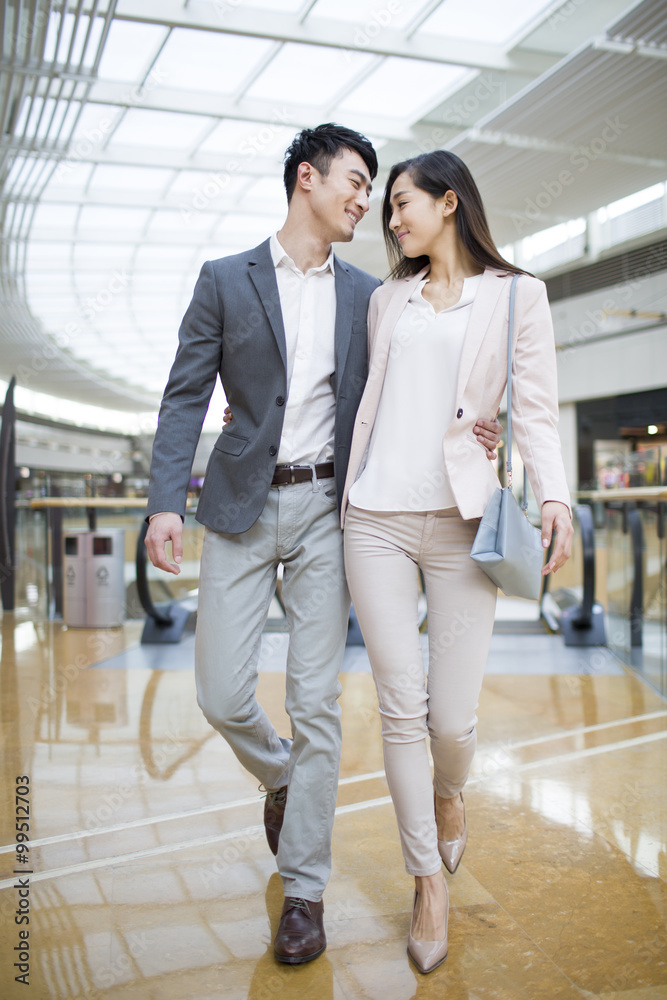 Young couple walking in shopping mall