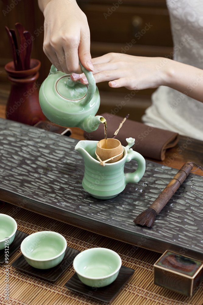 Young woman performing tea ceremony