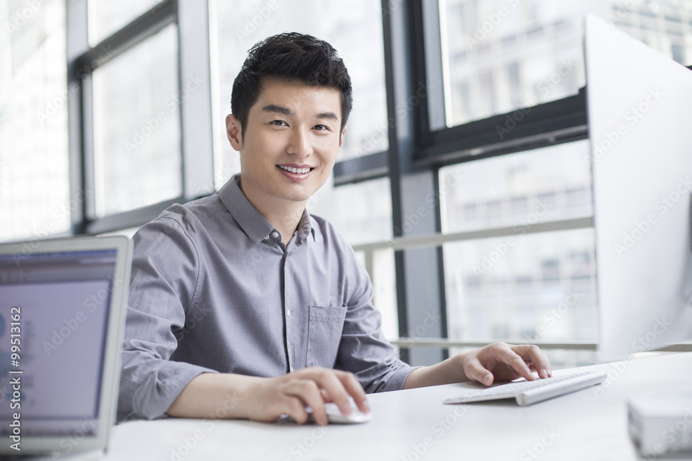 Young businessman using computer in office