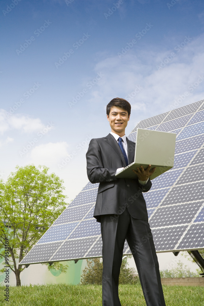 Portrait of a businessman in front of solar panels