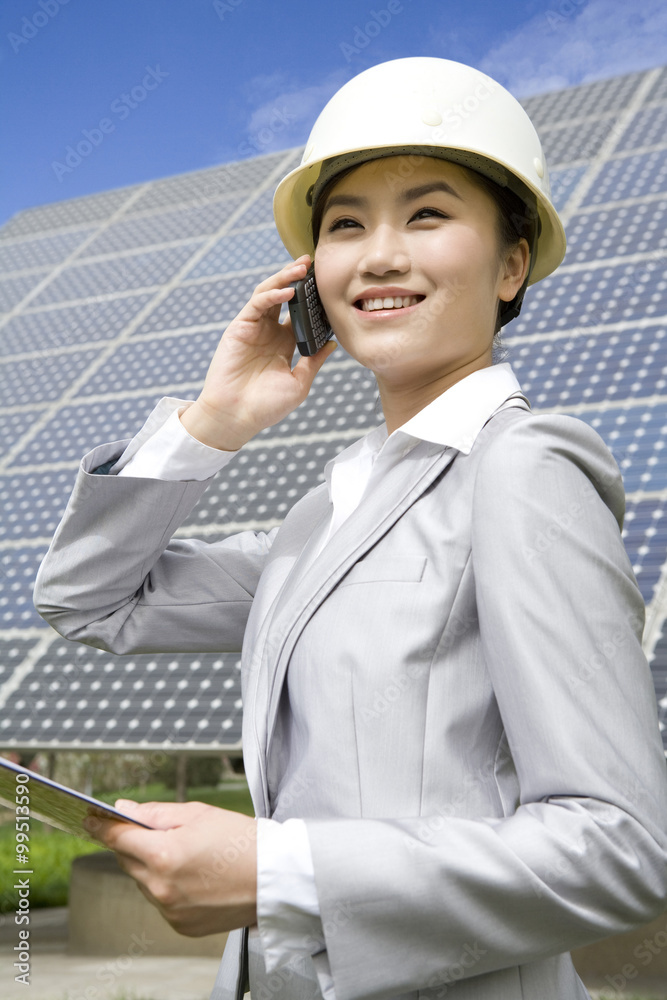 Portrait of an engineer in front of solar panels