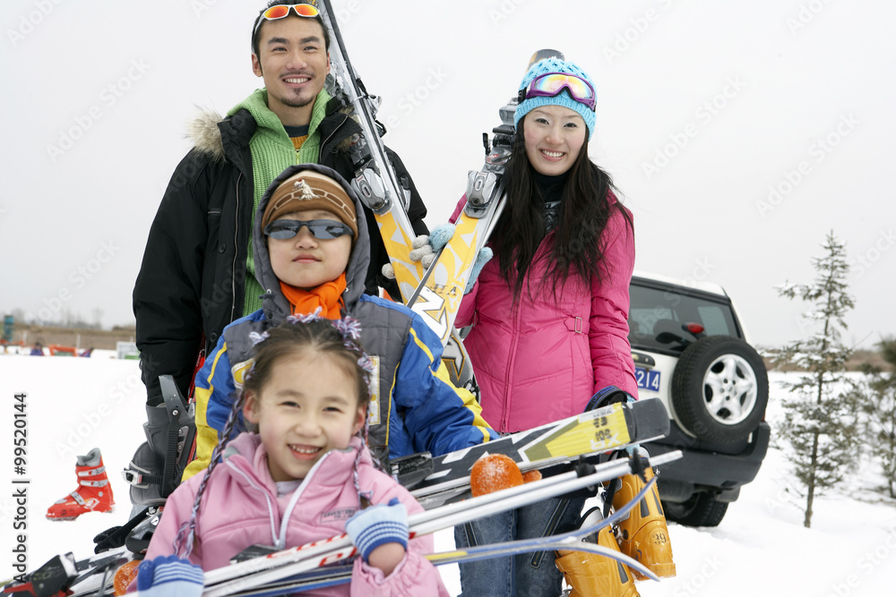 Young Family Preparing For A Day Skiing