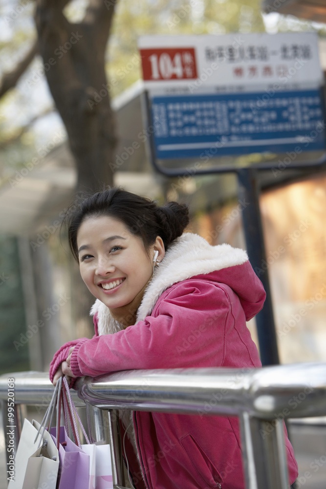 Young Woman Waiting At A Bus Stop