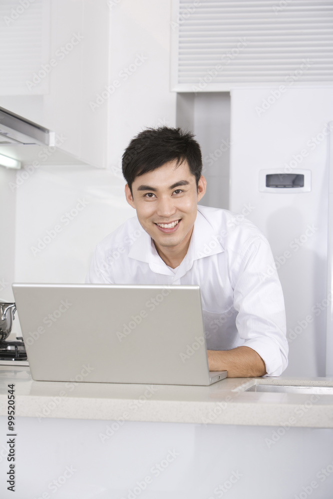 Man using laptop computer at home