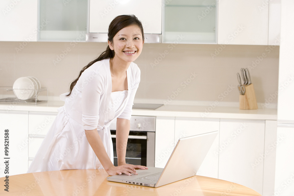 Young woman using laptop at home