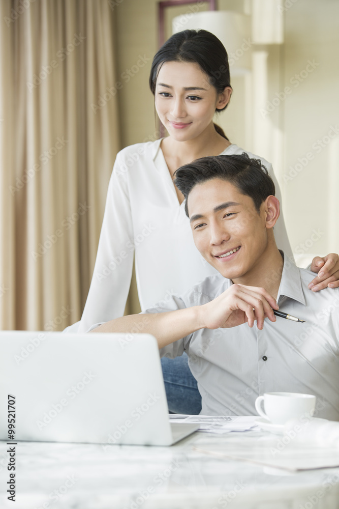 Young couple looking at laptop