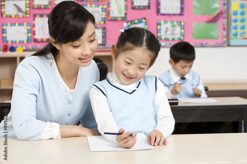 Teacher assisting student in class