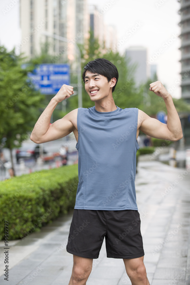 Young man flexing his muscles