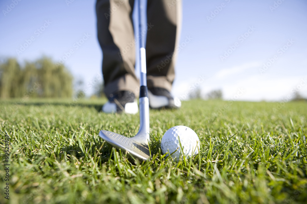 Golfer teeing off