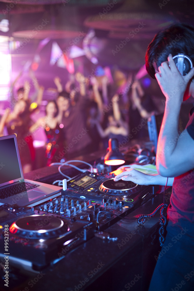 DJ doing record Scratching in nightclub