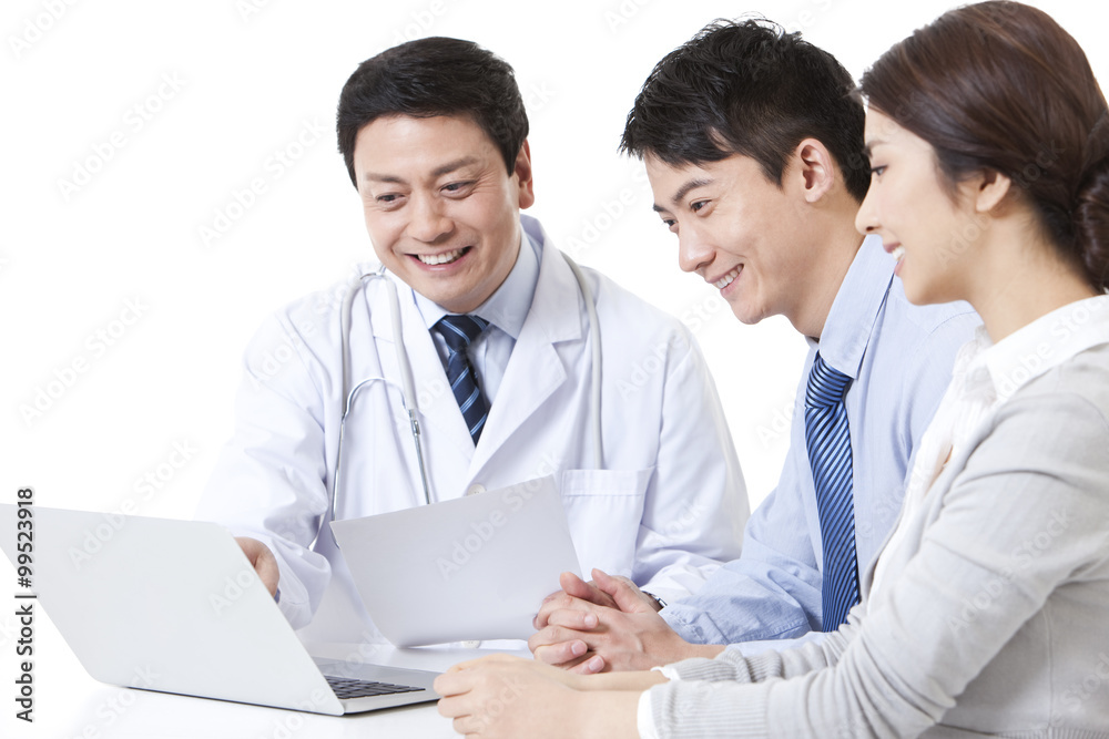 Happy young couple with doctor