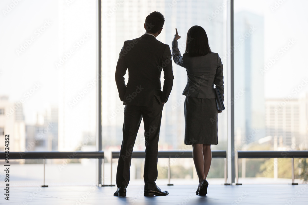 Business person looking through window