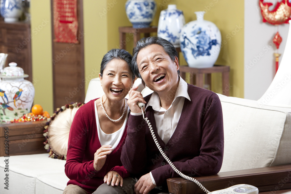 Senior couple on the phone during Chinese New Year