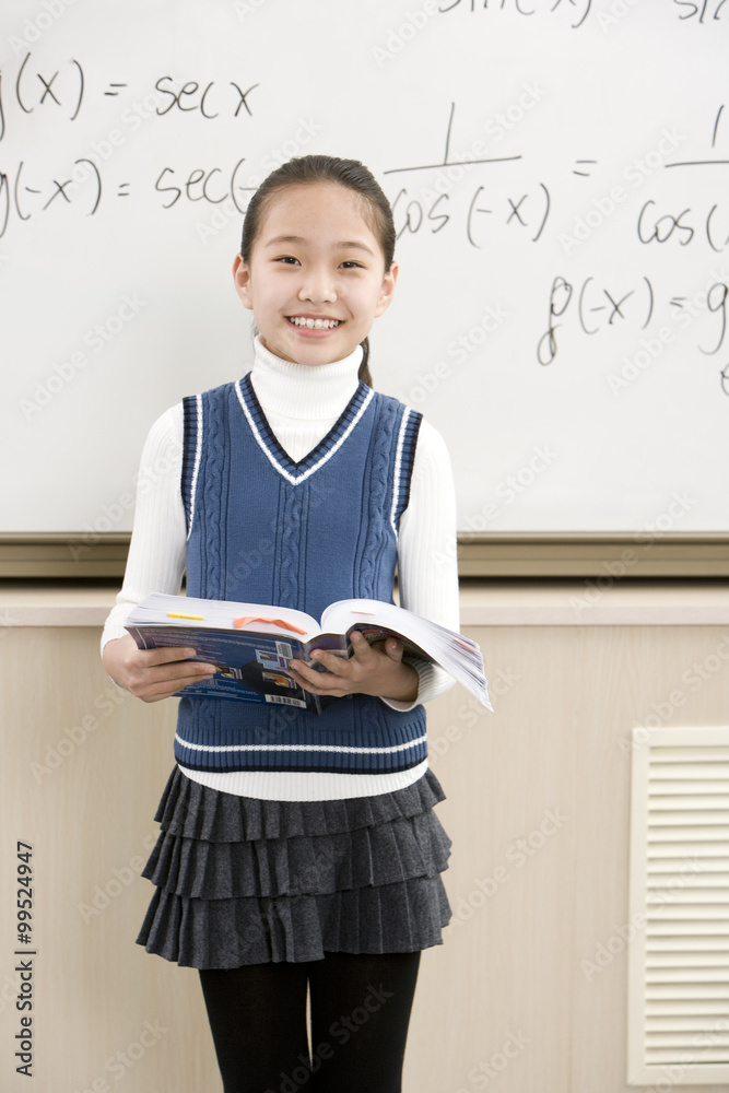 Confident student standing in front of math work