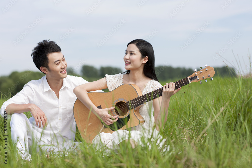 Young couple enjoying music outdoors