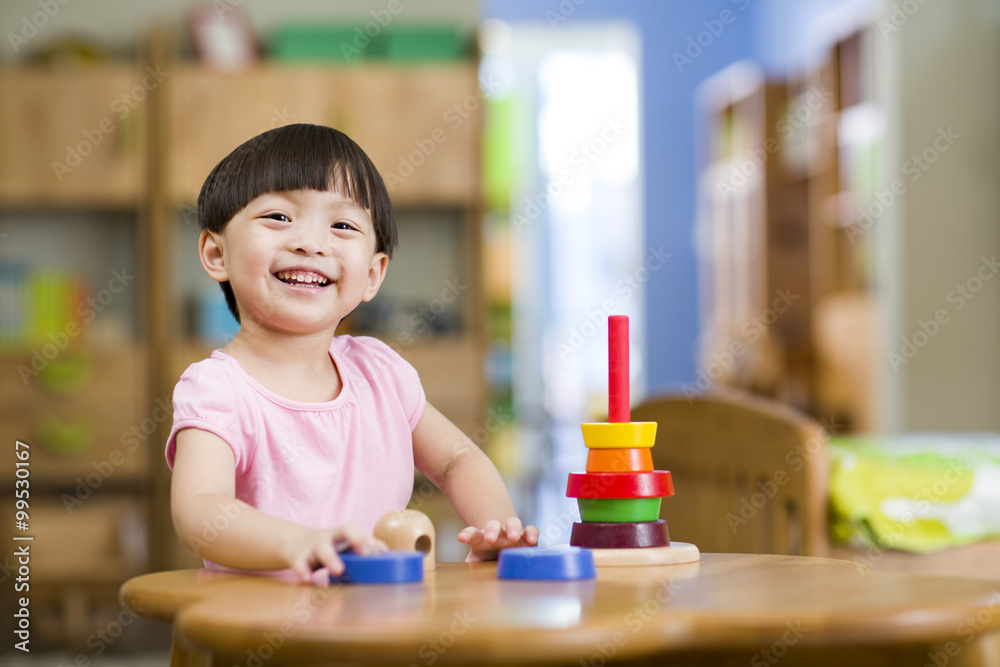 Cute girl playing with toys at home