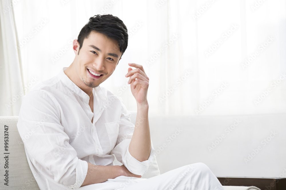 Young man resting in sofa