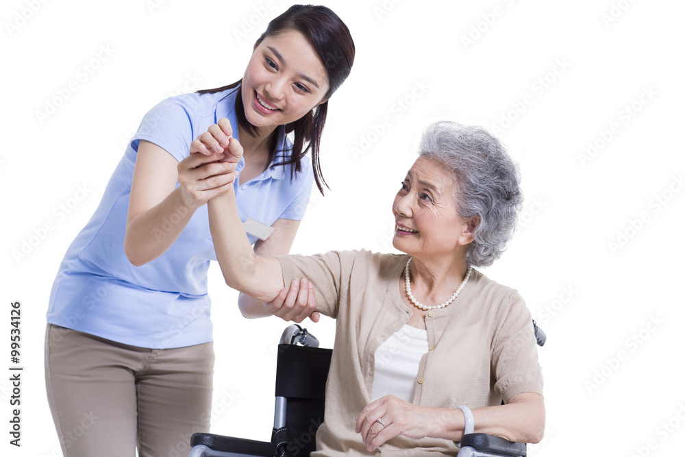 Female nursing worker helping senior man doing exercise