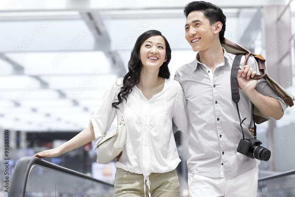 Young couple on escalator