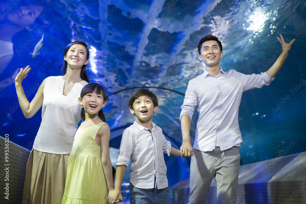 Young family in aquarium