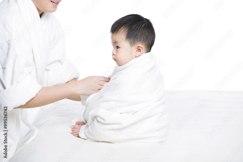 Mother wrapping baby in blanket