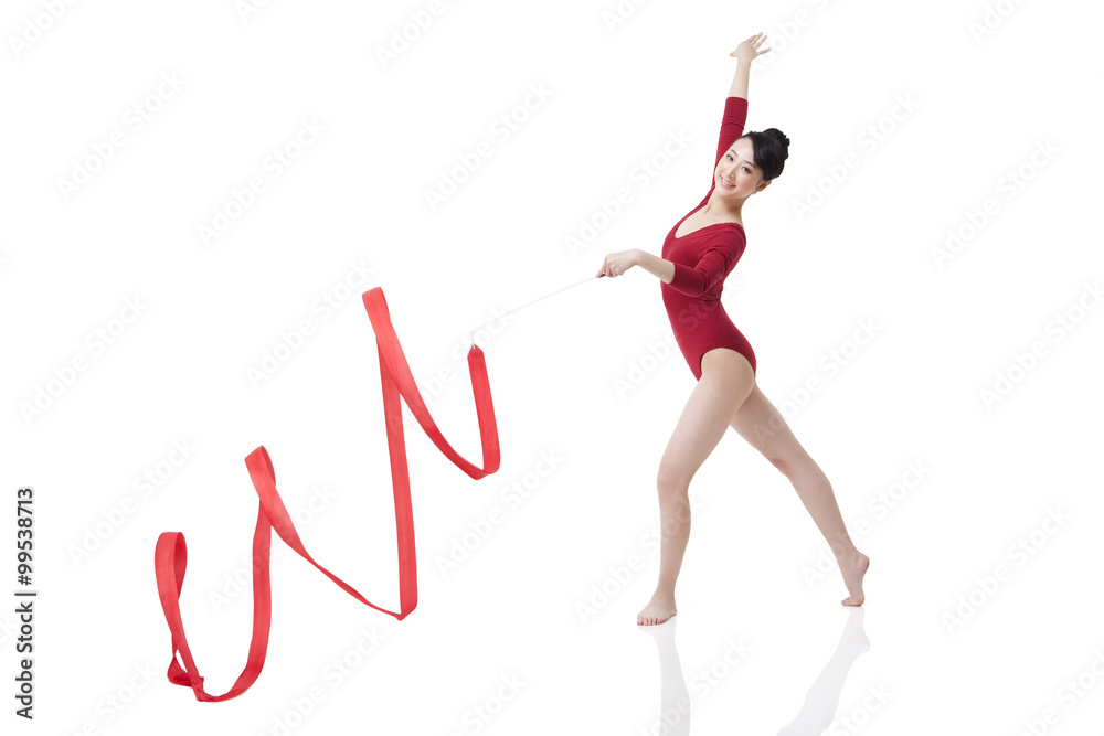 Female gymnast performing rhythmic gymnastics with ribbon