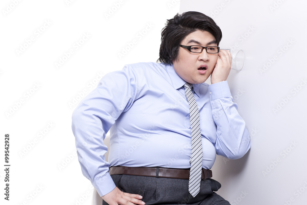 Overweight businessman doing eavesdropping