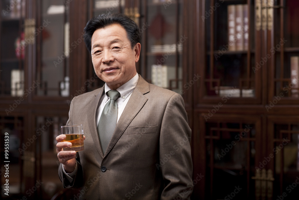 Successful businessman enjoying wine