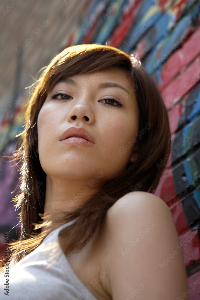 Teenage Girl Leaning On A Wall Of Graffiti