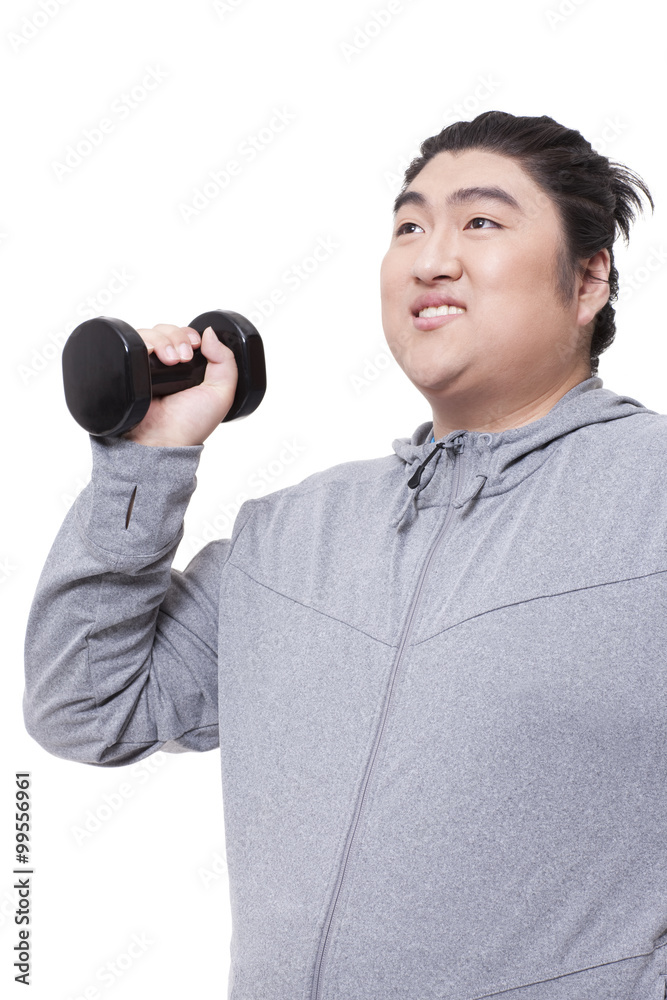 Overweight man exercising with dumbbell