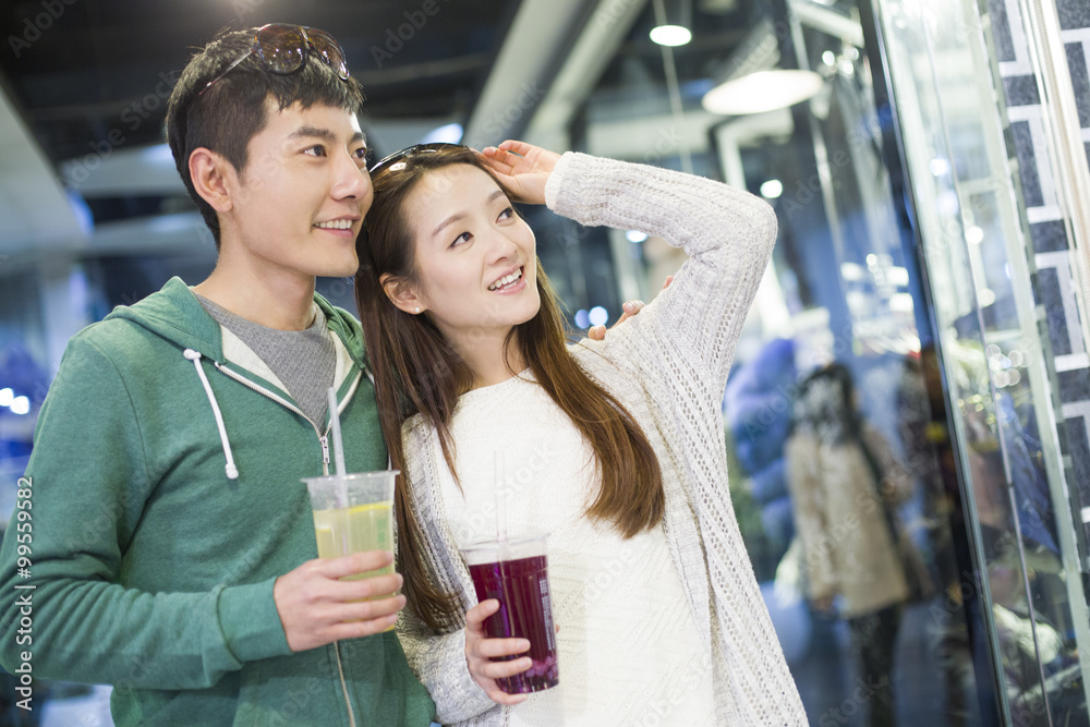 Young couple walking in shopping mall