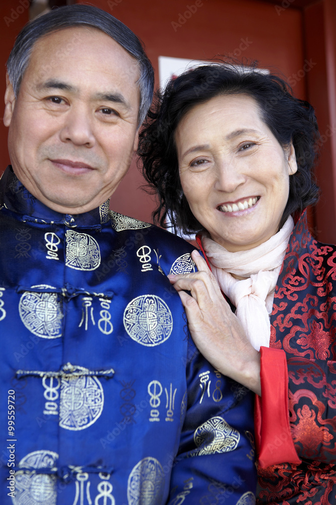 Traditionally Dressed Senior Couple Smiling At Camera