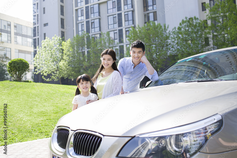 Happy young family and car